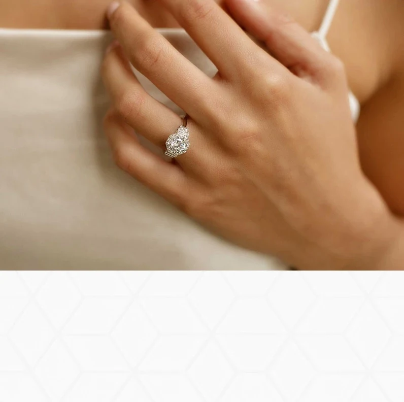 Woman wearing a three-stone halo diamond engagement ring from the luxury collection