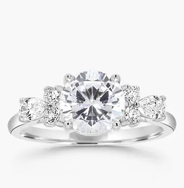 side stone engagement ring with round diamond